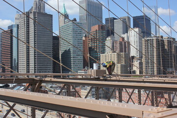 New York worker on Brooklyn bridge, painter, man at work maintenance