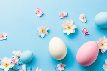 Obraz na płótnie Canvas Easter eggs, colorful flowers on a pastel blue background. Easter, spring concept. Flat lay, top view