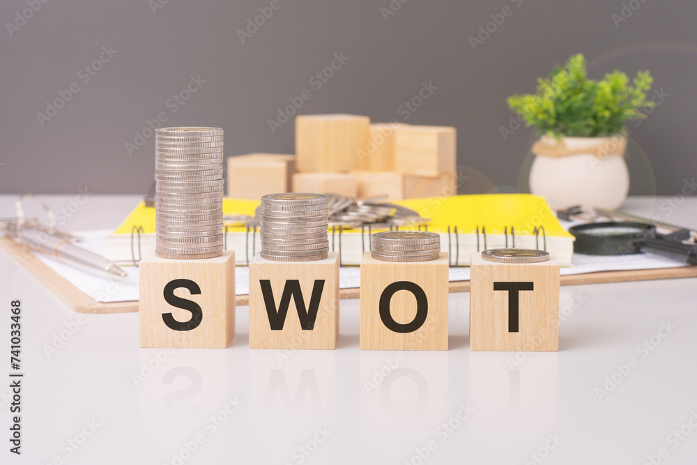 Poster swot text on wooden cube blocks with coins above