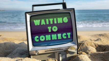 retro television on a beach next to the sea