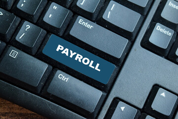 Payroll write on keyword isolated laptop background
