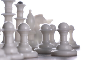 Close-up. White chess pieces on a chessboard. Light background.