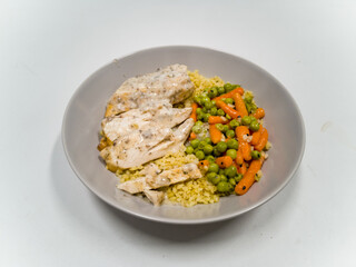 Colorful dish with rice, green peas and baby carrots with black sesame and  chicken slices in sauce