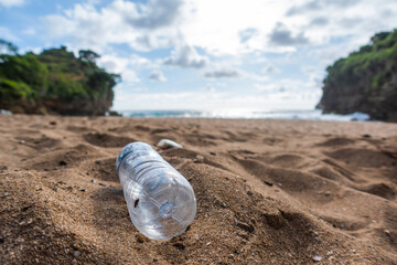 Plastic bottle trash on the beach. the beginning of the disaster. do not litter