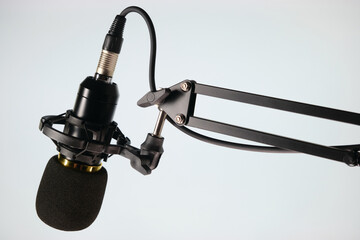 Studio microphone for podcast and voice recording on a gray background with space for inscription