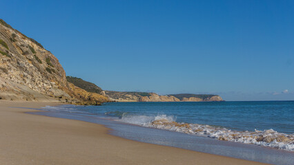 Fototapeta na wymiar Praia da Andorinha beach on a sunny day with clear blue sky, Algarve, Portugal.