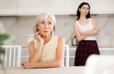 Quarrel of an elderly mother and adult daughter at home. Adult daughter is unhappy with elderly...