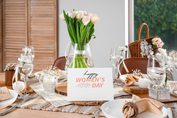 Stylish table setting with tulips and greeting card for International Women's Day celebration