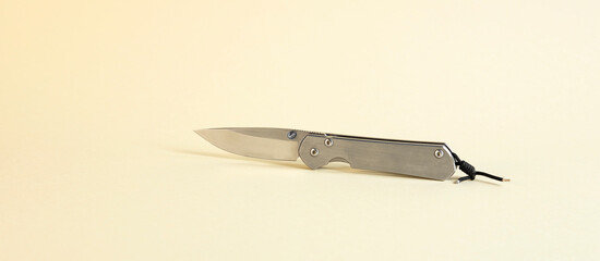 An isolated tourist knife on a beige background. The concept of hunting.