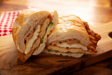Mexican Torta de Milanesa. Sandwich made with bolillo bread, telera or baguette, split in half and filled with various ingredients, in this case breaded chicken meat with Oaxaca cheese.
