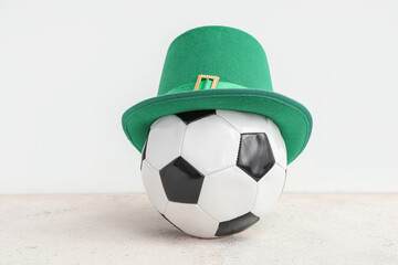 Soccer ball with leprechaun's hat on white grunge background. St. Patrick's Day celebration