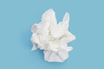 Crumpled tissue paper. Facial tissue on blue background.