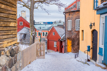 Houses in damstredet part of Oslo, old vintage historical buildings still found in the capital of Norway. Winter setting with snow, picturesque buildings and streets