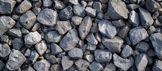 A stack of grey rocks, bedrock used as building material, creating a pattern resembling cobblestone. Often used in flooring or road surfaces - Powered by Adobe