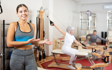 Young athletic woman in sportswear posing in pilates studio..