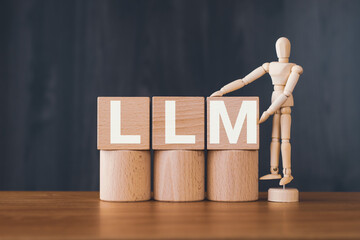 There is wood cube with the word LLM. It is an abbreviation for Large Language Models as eye-catching image. - obrazy, fototapety, plakaty