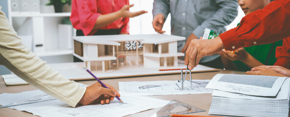Professional architect team select sustainable house materials while skilled engineer using divider...