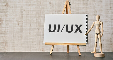 There is notebook with the word UIUX. It is as an eye-catching image. - obrazy, fototapety, plakaty