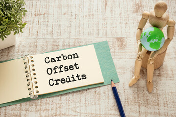 There is notebook with the word Carbon Offset Credits. It is as an eye-catching image.