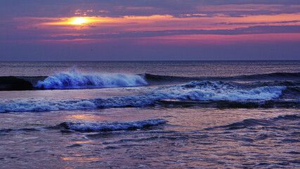 Scenic sunrise seascape view of waves along the the shore of the Outer Banks in Nags Head, North...