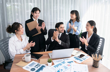 Diverse group of business analyst team analyzing financial data report paper on office table. Chart...