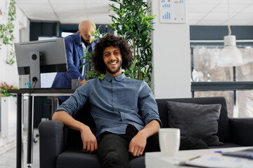 Smiling successful arab start up company entrepreneur in business office portrait. Young handsome...