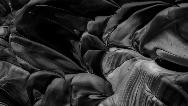 Vibrant, colorful, fluid and wavy abstract paint seamless loop animation. Modern and contemporary style in 4K with shades of black, white, gray