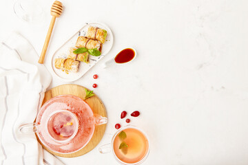 Aesthetic table setting - glass teapot of natural healthy cranberry tea and traditional turkish...