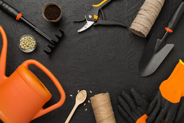 Orange gardening tools on conctere background, top view