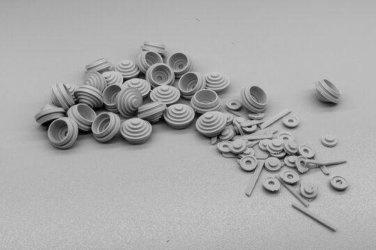 An assortment of white ceramic insulators on a grey surface