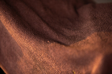 Close up of brown fabric texture background. Selective focus. Toned.