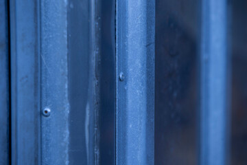 blue metal fence, closeup of photo with shallow depth of field