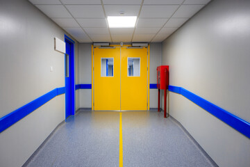The door at the end of the hospital corridor. Background with selective focus and copy space