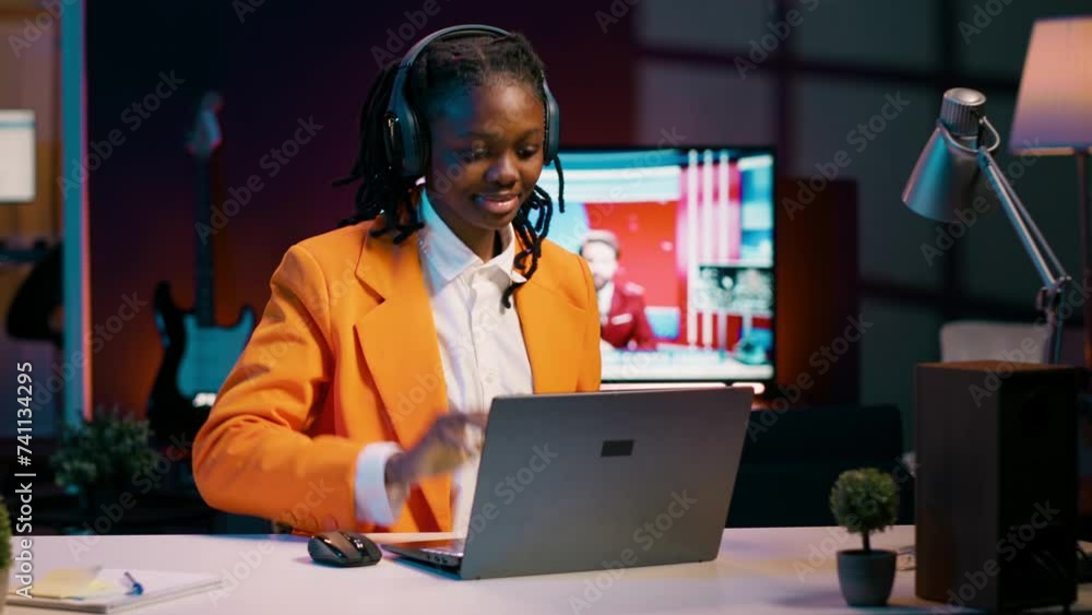 Poster african american pupil resolving project tasks with music on her headphones, creating a relaxing atm