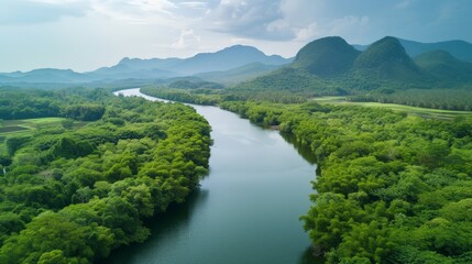 Fototapeta na wymiar Beautiful natural scenery of river in southeast Asia tropical green forest with mountains in background, aerial view drone shot