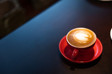 Latte art, coffee shop, red cup, wooden table, simple restaurant, ceramic texture, cafe decoration, interior decoration,coffee mug,red,brown,SHOTLISTeco,no plastic