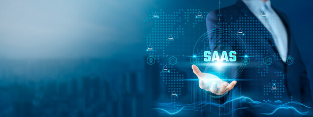 SaaS: Businessman Holding Software-as-a-Service (SaaS) Solutions on Global Technology Network, Scalability, Flexibility, Cost-Efficiency, Innovation.