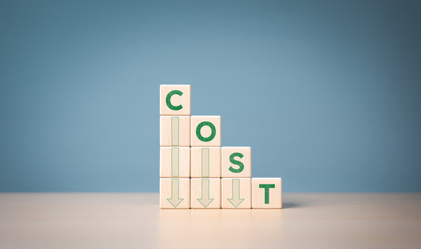 Lean optimize manufacturing and Cost reduction management concept. Decrease company expenses to maximize profits. Stacked wooden cube with green word cost and down arrow icons. Business improvement.