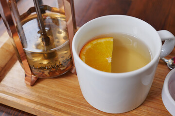 Top view of lemon tea pouring in a cup