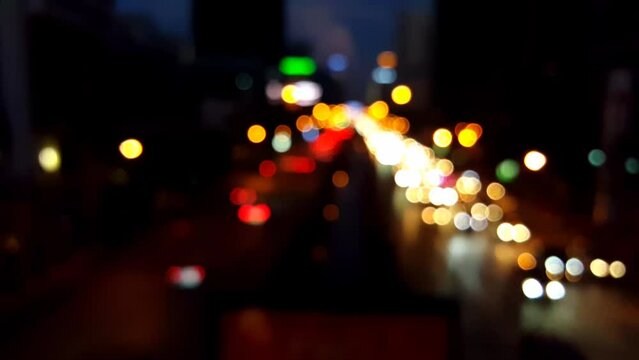 Blurred background night city bokeh car drive on road in nightlife. Light line traffic jam in black night. Blur street flare traffic motion movement. Cityscape Urban dark background twilight time