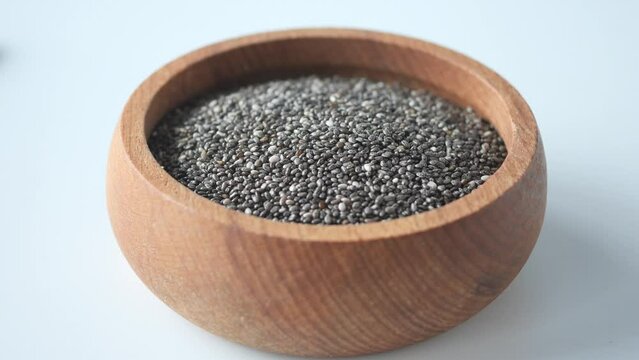 closeup of chia seeds pouring in a bowl 