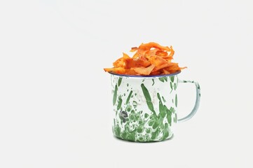 cassava chips in a patterned cup in isolated white background