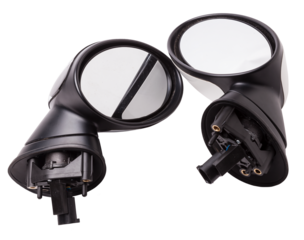 Close-up on a pair of side mirrors from a minibus with turn signal repeaters for repair and replacement after an accident in a workshop. Auto service industry. Spare parts catalog.