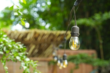 Hanging lamp with blurry background. Outdoor location. Lampu