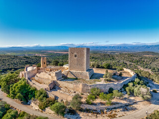 Fototapeta na wymiar Aerial view of Ulldecona castle, Serra Grossa mountain top, former frontier fortified complex old church, emblematic circular tower and square keep
