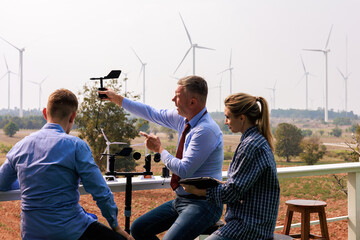 Engineer team hold equipment and tablet sitting to meeting planing project install wind turbines in...