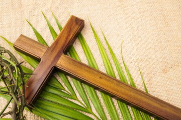 Illustration of Jesus Wooden cross with palm leaves and Crown of Thorns used by Catholic Christians...