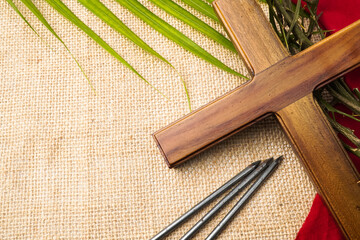 Jesus Wooden cross with nails, palm leaves, red cloth and Crown of Thorns. Catholic Christians Good...