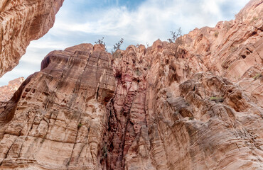 The bizarre beauty of high mountains on sides of gorge of tourist route of gorge Wadi Al Ghuwayr or...