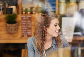Coffee shop, relax and woman in window with laptop for internet, social networking and website. Happy, smile and person on computer in restaurant, cafe and diner for caffeine, beverage and cappuccino